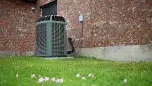hvac Central Air Conditioning System installed in a home with green garden