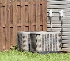 istockphoto-2166795226-2048x2048 Two central air conditioning units installed outside a residential home